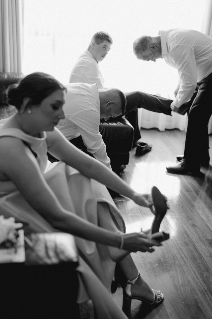 Bridal party putting shoes on